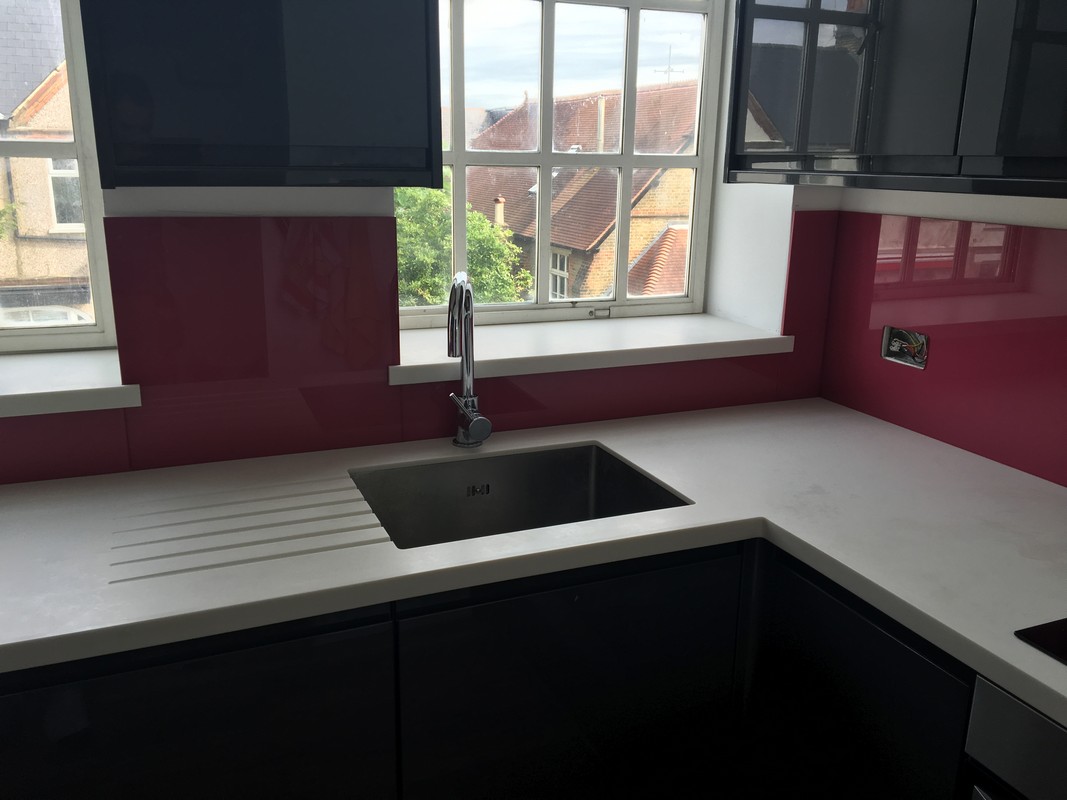 Deep plum coloured glass splashback in modern Barnet kitchen